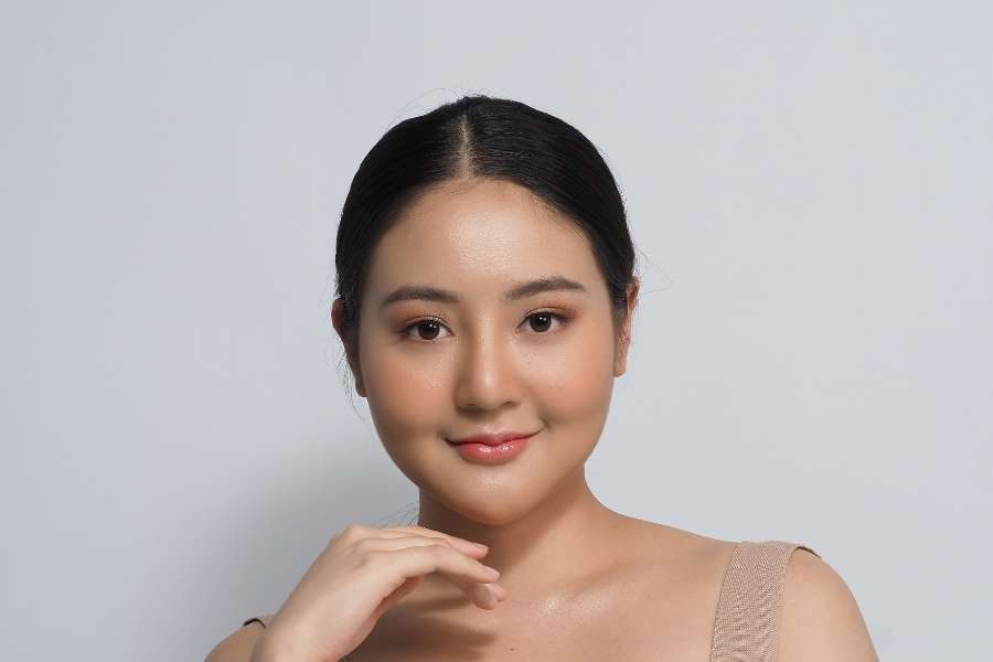 Un portrait de femme illustrant la tendance du Clean Girl Look avec un maquillage minimaliste et lumineux.